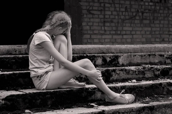 Foto Monokrom. Tersinggung marah gadis remaja duduk di tangga beton tua luar — Stok Foto