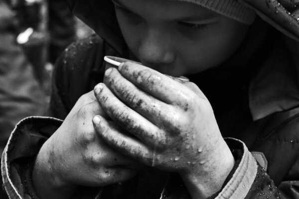 Monochrome photo. The problem of street children orphans. Beggar refugees on the s