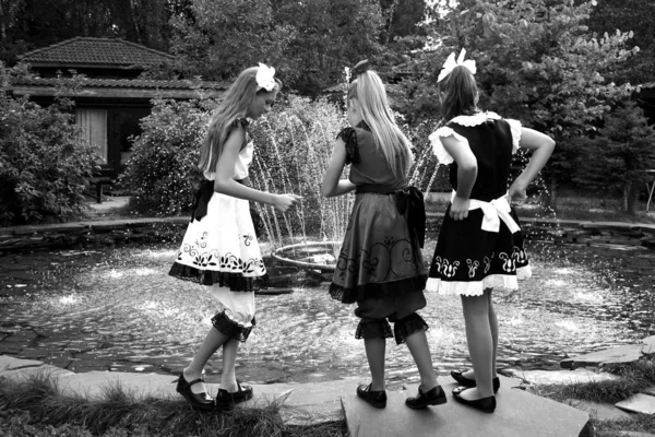 Monochromes Foto. Models Drei Mädchen in eleganten Kleidern bereiten sich auf die Perf vor — Stockfoto