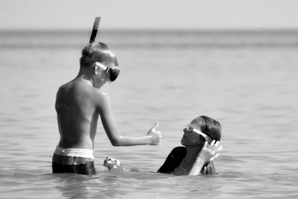 Monochrome photo. Friendly children of the sea. Children in the water masks. — Stockfoto