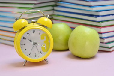 Okul kitapları ve yeşil elmalar. Öğrencinin sağlıklı bir kahvaltısı. Eğitim ve yemek..