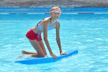 The water rides in the tropics. Girl swims in the water Park.