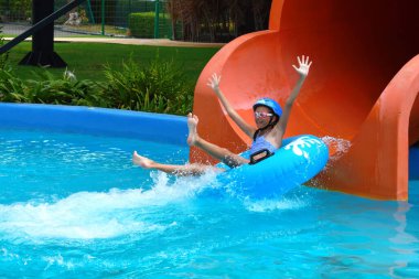 The water rides in the tropics. Girl swims in the water Park.