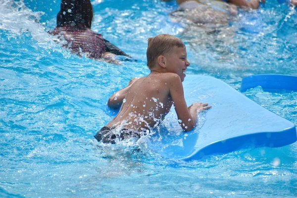 Baby boy on a water Board. Stay in the water Park in the summer. — Stockfoto