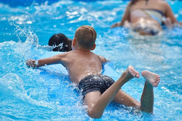 Baby boy on a water Board. Stay in the water Park in the summer. — Stock fotografie