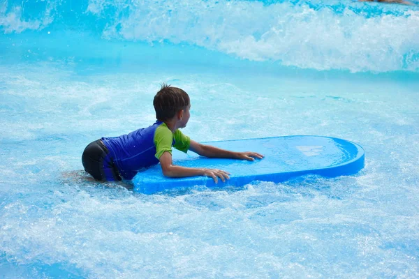 Baby boy on a water Board. Stay in the water Park in the summer. — Stockfoto