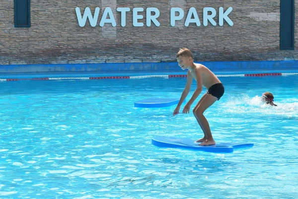 Baby boy on a water Board. Stay in the water Park in the summer. — Stockfoto