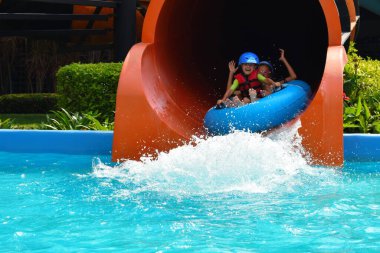 Happy child in the water Park. Girl in the pool in the summer autdoor.