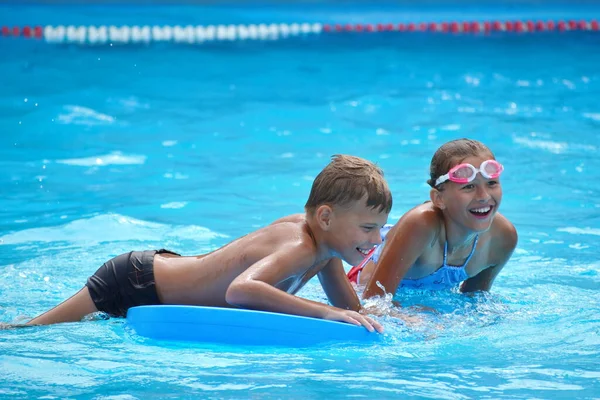 Brother and sister on vacation. Funny kids at the water Park. Friendly boy and girl. — Stock fotografie