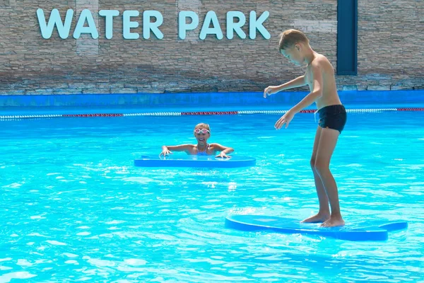 Brother and sister on vacation. Funny kids at the water Park. Friendly boy and girl. — Stockfoto
