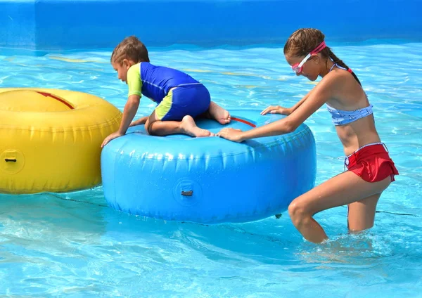 Brother and sister on vacation. Funny kids at the water Park. Friendly boy and girl. — Stock fotografie