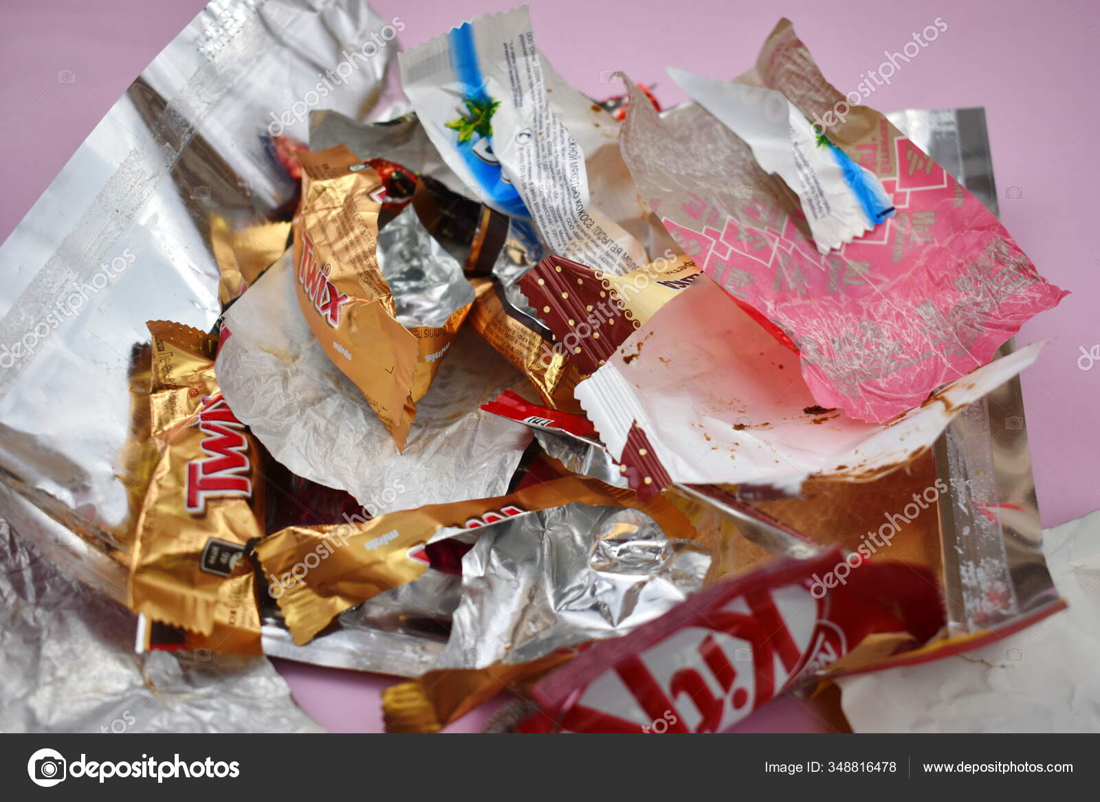 Empty candy wrappers on the table. Eating a lot of sweets Stock