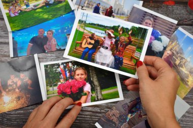 Elinde fotoğraf tutan bir kadın. Aile fotoğrafları ayarlanıyor. Aile fotoğrafı albümünü izle.