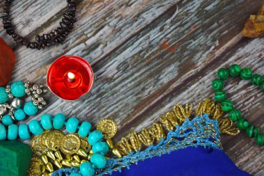 The occult and esoteric background. Candles, stones and beads on the table. Magic and magic