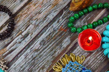 The occult and esoteric background. Candles, stones and beads on the table. Magic and magic