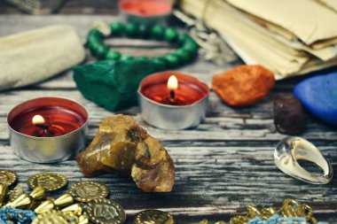 The occult and esoteric background. Candles, stones and beads on the table. Magic and magic