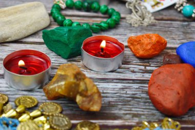 The occult and esoteric background. Candles, stones and beads on the table. Magic and magic