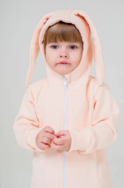 A little girl of two years in the Studio. Children's clothing store. — Stock Photo, Image