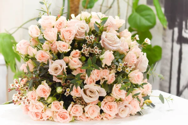 Fresh pink flowers on table. A bouquet of delicate flowers. Floral gift for the woman. Flowers in interior