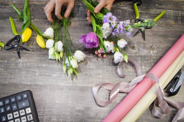 Masada çiçek buketleri var. Çiçek arkaplan. Çiçekçinin aletleri..