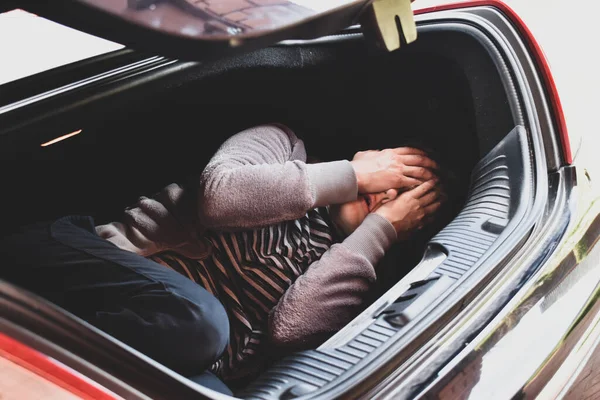Victim lies in the trunk. The car is a crime. Captive in the car — Stock Photo, Image