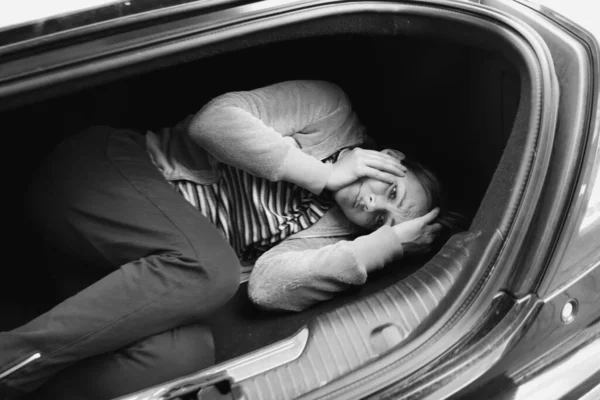 The woman in the car trunk. Stealing women into slavery. — Stock Photo, Image