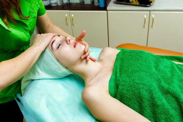 Young caucasian woman getting  face massage in spa salon — Stock Photo, Image