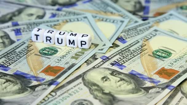 Word from cubes "trump" on the spinning surface of American dollars — Stock Video