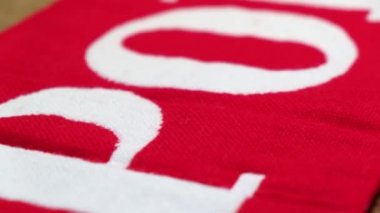 Closeup of red - white fan - scarf with the Eagle - national emblem of Poland.