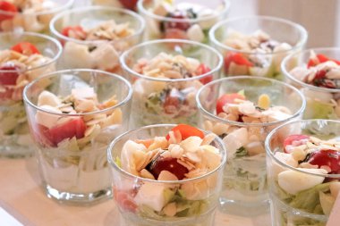 Vegetable appetizers in glasses on a banquet table. Treats for g