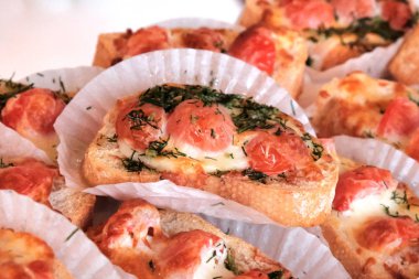 Appetizers bruschetta with tomatoes and cheese on a banquet tabl