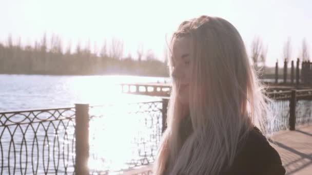 Portrait Beautiful Young Woman Standing River Embankment City Sunny Windy — Stock Video