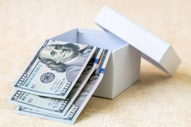 Beyaz hediye kutusunda 100 dolarlık üç ABD Doları banknot. Stu!