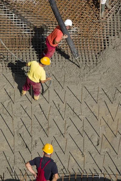 Workers on concrete background — Stock Photo, Image