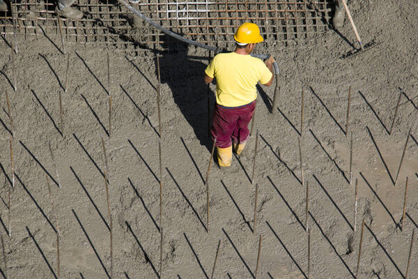 Worker on concrete background