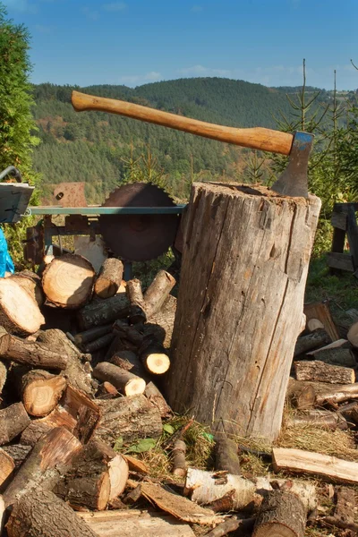 Vecchia ascia su tronco e legna da ardere. Ascia tagliata a legna dopo aver tagliato la legna da ardere . — Foto Stock