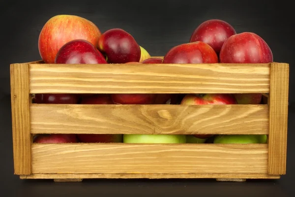 Fresh red autumn apples in farmhouse style wooden crate. Sales of farm products. Advertising for the sale of fruit.