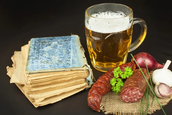 Glass of beer, bratwurst and a book on wooden background. Relax with a book. — Stock Photo, Image