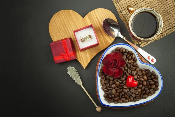 Romantic coffee. Marriage proposal. Coffee beans and a gold ring. Breakfast for lovers. Declaration of love on Valentine\'s Day.