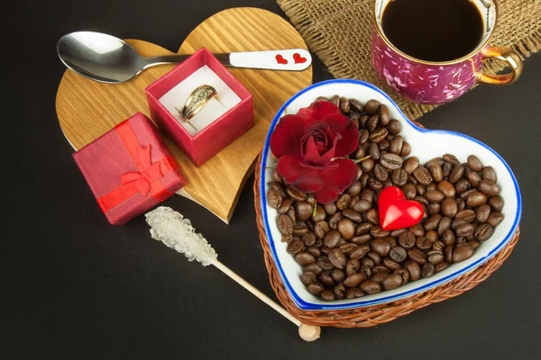 Romantic coffee. Marriage proposal. Coffee beans and a gold ring. Breakfast for lovers. Declaration of love on Valentine\'s Day.