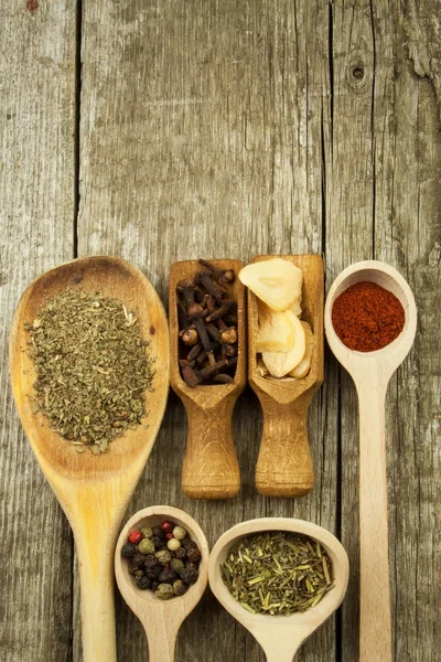 Spice in Wooden spoon. Herbs. Cinnamon and other on a wooden rustic background. Pepper. Large collection of different spices and herbs. Salt, paprika. Sale of spices.