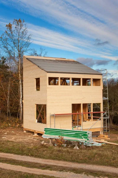 Construction of ecological house. External work on the building envelope. The wooden structure of the house near the forest.