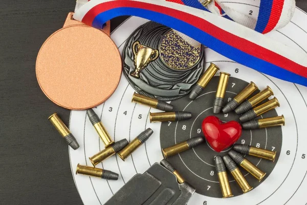 Shooting competition. Award winners. Biathlon victory. Ammunition and winners medals in biathlon. Diploma of shooting competitions. Background diploma.