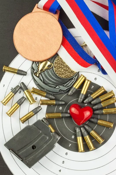 Shooting competition. Award winners. Biathlon victory. Ammunition and winners medals in biathlon. Diploma of shooting competitions. Background diploma. Bullet caliber .22