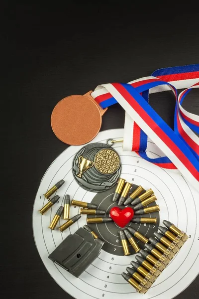 Concept of shooting competitions. Sport shooting. Biathlon background diploma. Tools and targets on wooden background. Caliber ,22