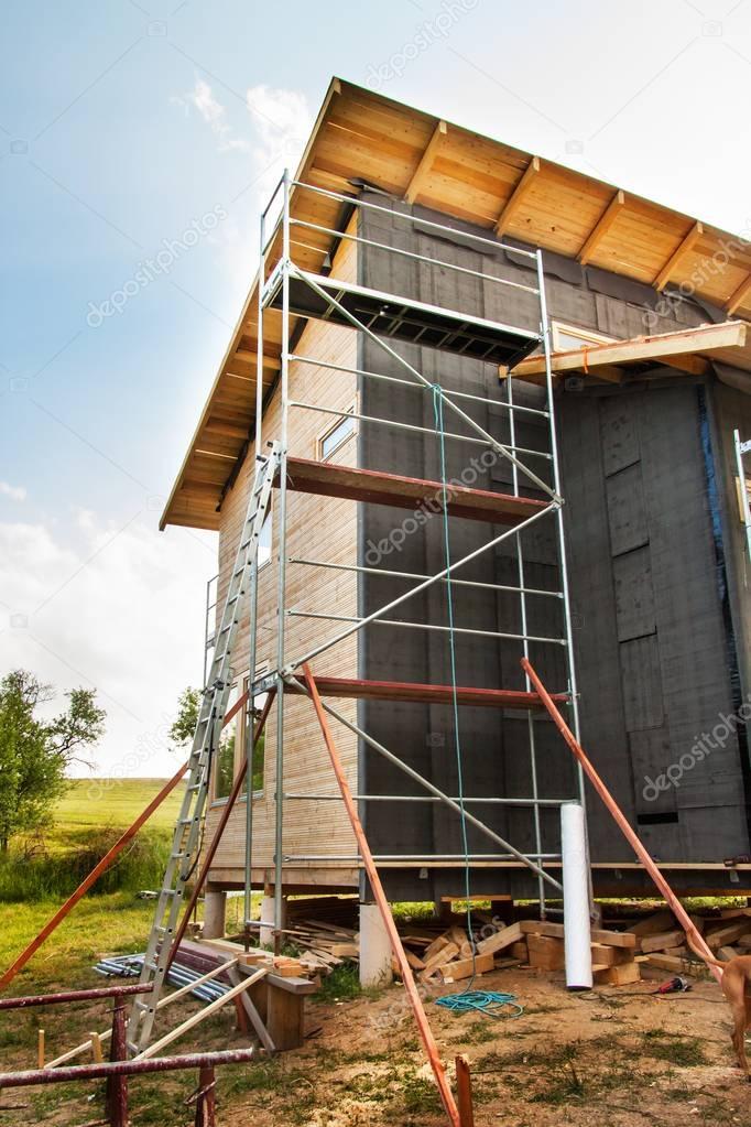 Construction of an ecological wooden house. Insulation of walls and roofs.