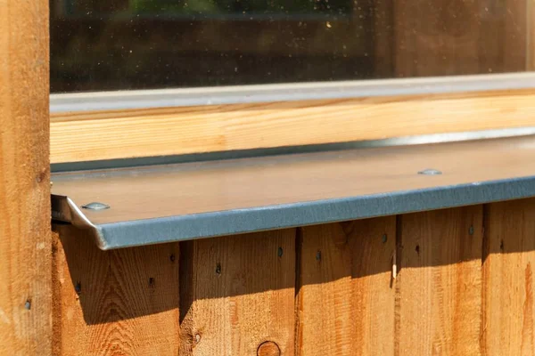 Sheltered window sill. Galvanized sheet metal on the window. Building an eco-house. — Stock Photo, Image