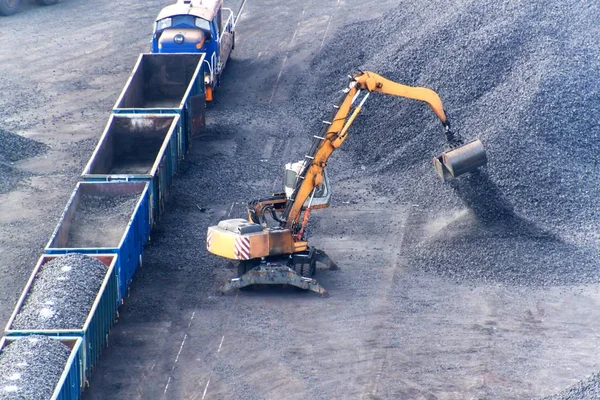 Work in port coal transshipment terminal. Coal unloading of wagons with special cranes. Working in a port near the Baltic Sea. — Stock Photo, Image