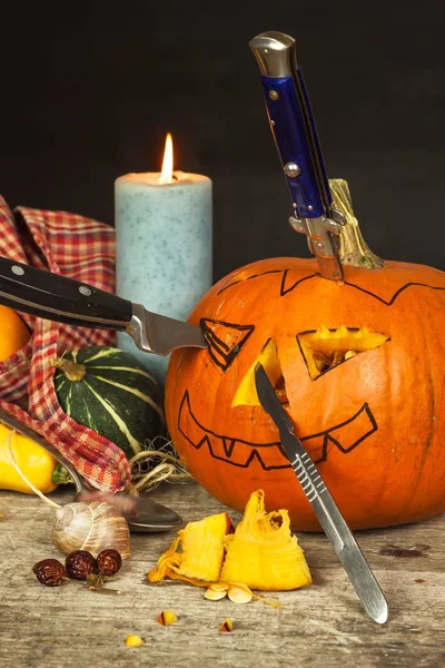 Making Jack o lantern. Carving the pumpkin. Hollowing out a scary pumpkin to prepare halloween lantern.