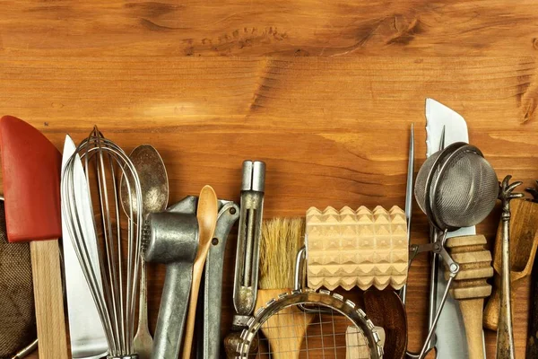 Старий кухонний посуд на дерев'яній дошці. Продаж кухонного обладнання. Інструменти шеф-кухаря . — стокове фото